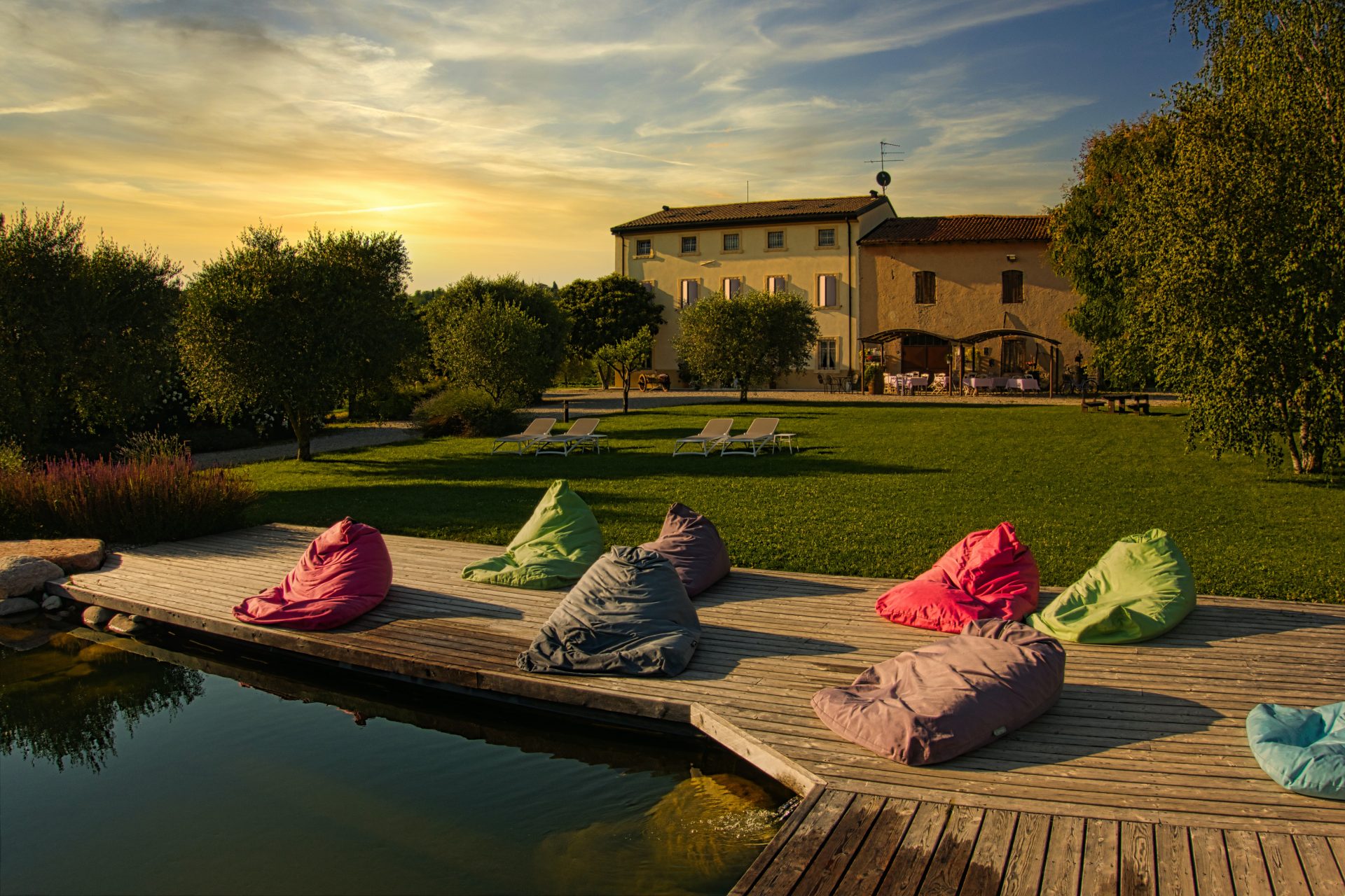 Beanbags infront of a swimming pool in the gardens of a beautiful country property